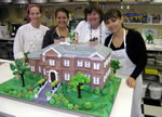 Colette Peters with a house cake